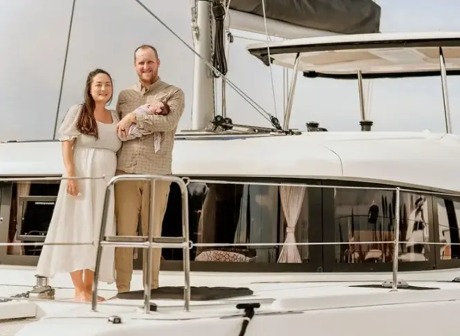 Michelle Schroeder-Gardner and her husband standing on sailboat