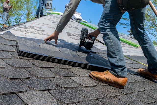 roofer installing shingles