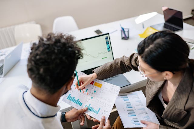 two colleagues looking at graphs