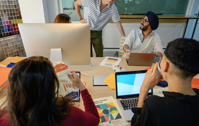 A group of diverse professionals collaborate on a design project