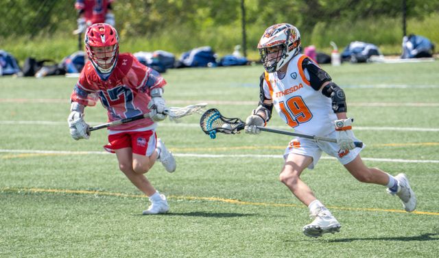 Two young lacrosse players in action during a match