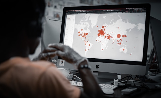 person looking at heatmaps on a global map
