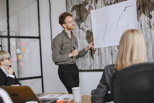 man showing stats on a whiteboard