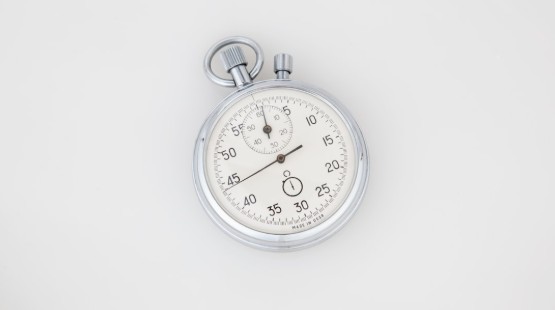A mechanical stopwatch lying face up